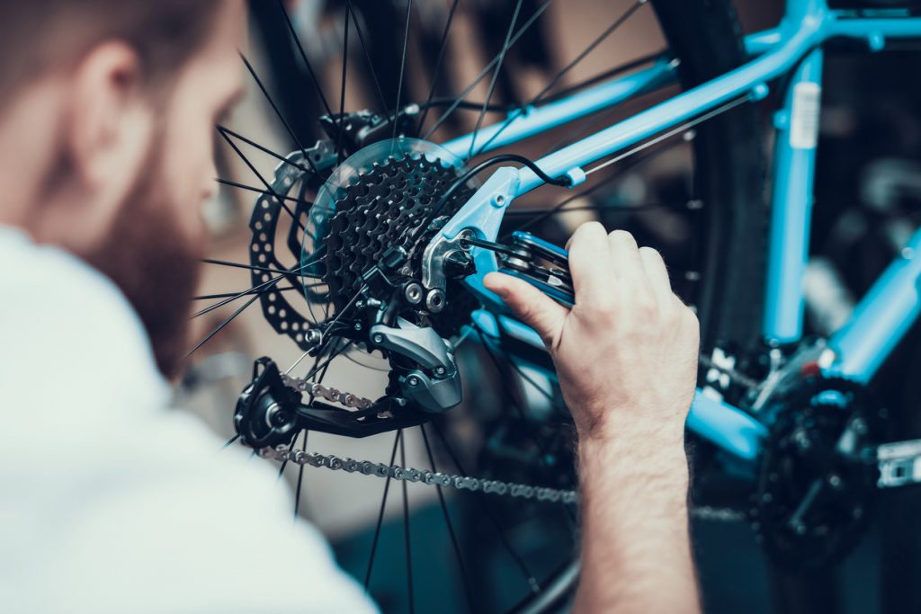 bike-mechanic-repairs-bicycle-in-workshop-peoriabicycleclub