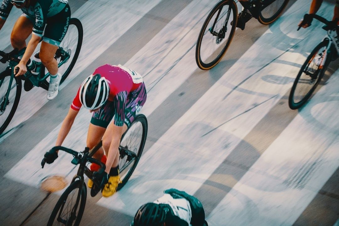 Cyclists ride closely together in an overhead view of a group ride